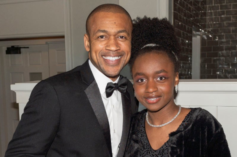 Photo of Dr. Patrick Willis and his daughter, smiling at the camera.