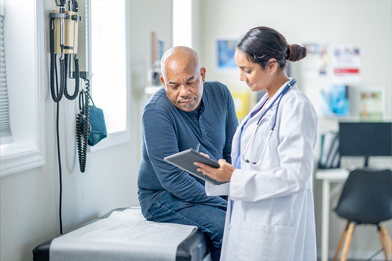Doctor discussing the community pharmacy benefits at St. Mary's healthcare system with a patient.