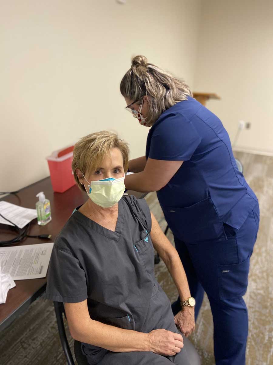 nurse receiving covid vaccine